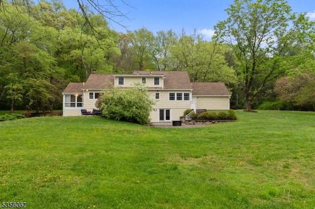 back of property featuring a yard