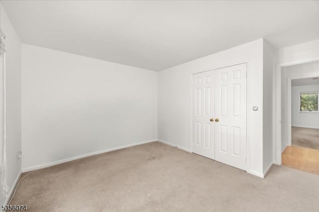 41 Troon Ter, Clinton Twp, NJ 08801 - unfurnished bedroom featuring light carpet, baseboards, and a closet