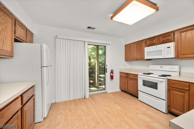 41 Troon Ter, Clinton Twp, NJ 08801 - kitchen with white appliances, light wood-type flooring, light countertops, and brown cabinetry
