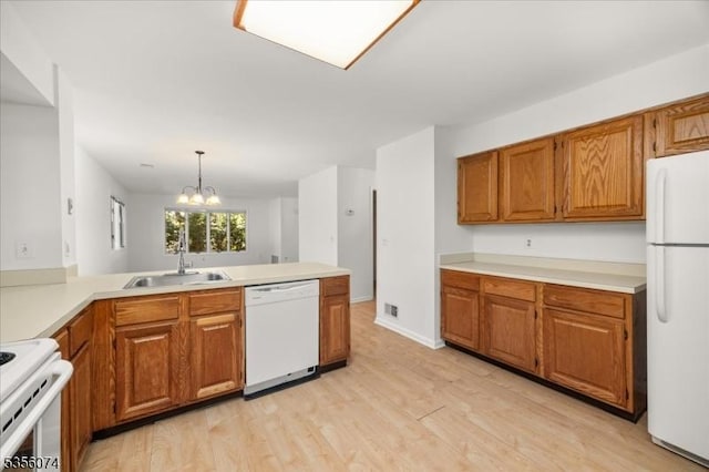 41 Troon Ter, Clinton Twp, NJ 08801 - kitchen featuring white appliances, a sink, brown cabinets, a chandelier, and light countertops