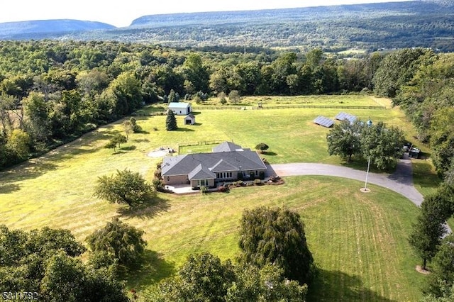 view of rural area with a forest