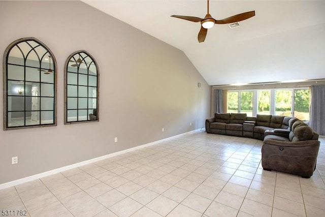 living area with vaulted ceiling, a ceiling fan, light tile patterned floors, and baseboards
