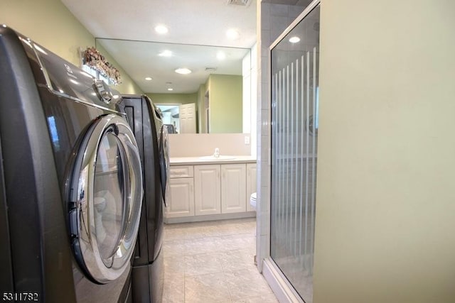 laundry room with a sink, recessed lighting, and light tile patterned floors
