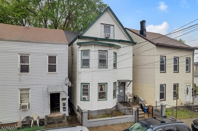 124 E Main St, Paterson City, NJ 07522 - back of house featuring a fenced front yard and cooling unit
