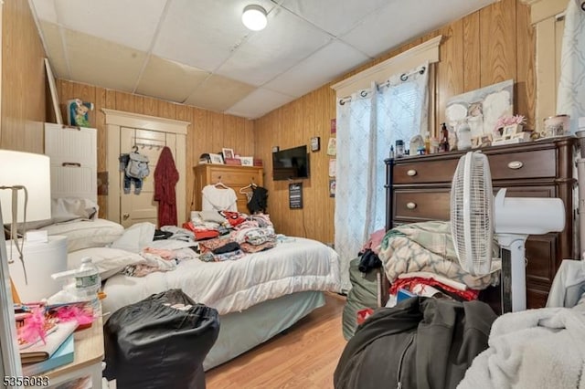 124 E Main St, Paterson City, NJ 07522 - bedroom with wood walls, wood finished floors, and a drop ceiling