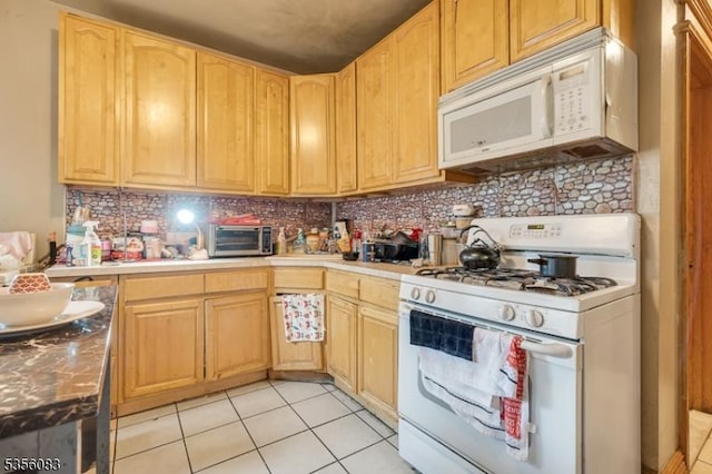 124 E Main St, Paterson City, NJ 07522 - kitchen featuring white appliances, light tile patterned flooring, light brown cabinets, and tasteful backsplash