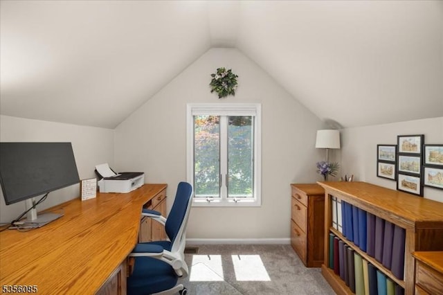 carpeted home office with lofted ceiling and baseboards