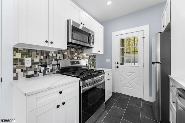 19 Oak Rd, Boonton Twp, NJ 07005 - kitchen featuring appliances with stainless steel finishes, tasteful backsplash, white cabinets, recessed lighting, and dark tile patterned flooring