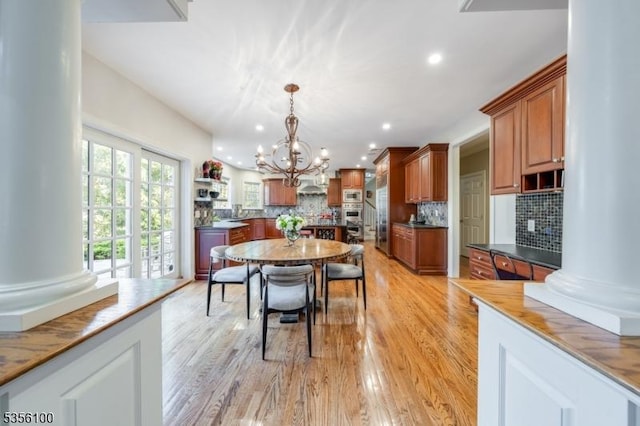 dining area with a chandelier, light wood-type flooring, and recessed lighting