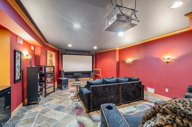 home theater room with ornamental molding, recessed lighting, baseboards, and stone finish flooring