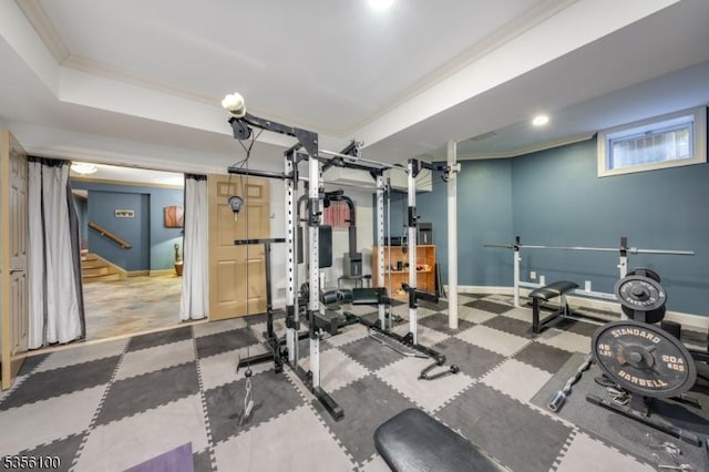 workout room featuring baseboards and crown molding