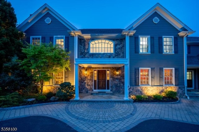 view of front of property with stone siding and a porch