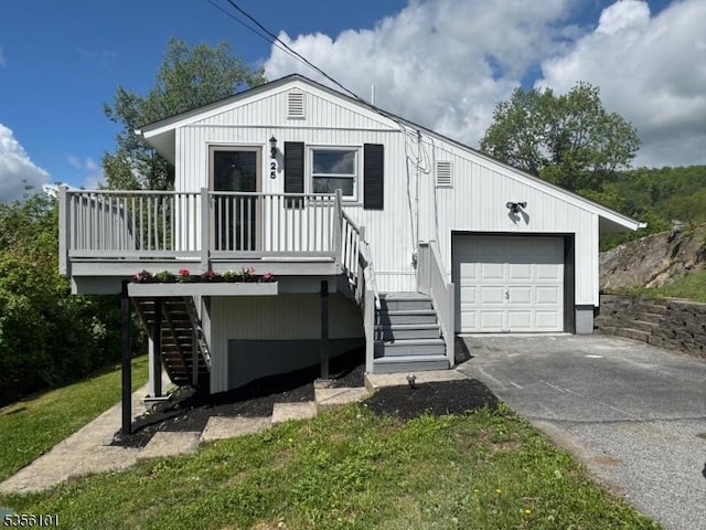 25 Ivy Pl, Vernon Twp, NJ 07418 - view of front facade with stairway, driveway, and a detached garage