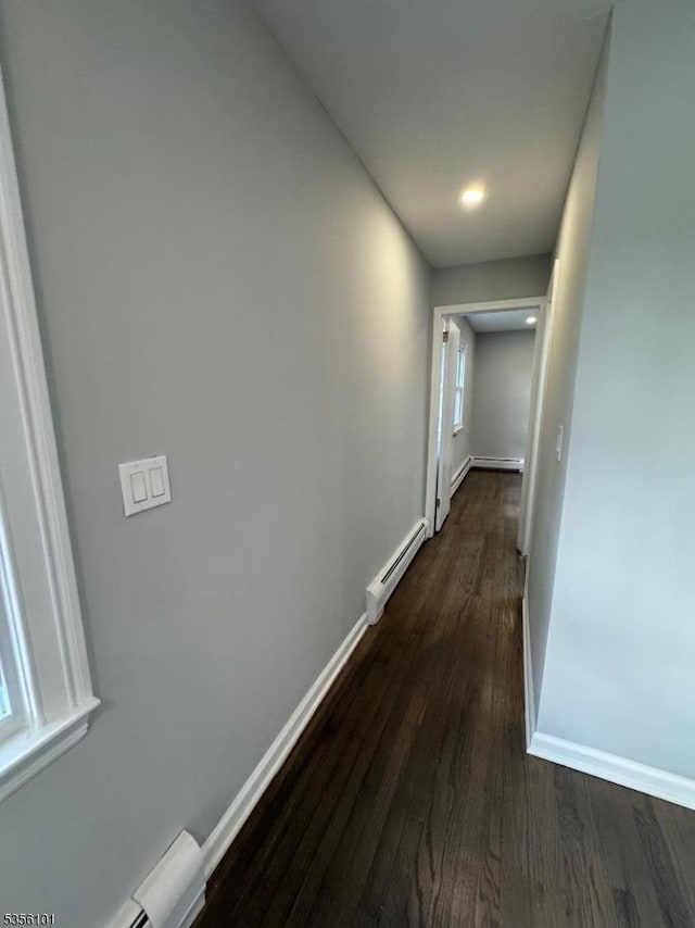 25 Ivy Pl, Vernon Twp, NJ 07418 - hallway featuring baseboard heating, dark wood-type flooring, and baseboards
