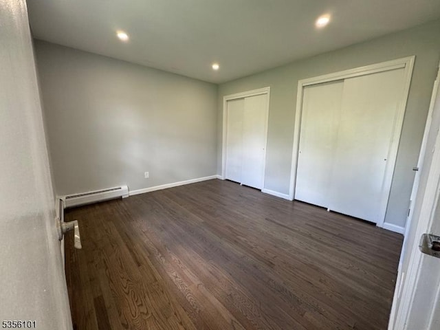 25 Ivy Pl, Vernon Twp, NJ 07418 - unfurnished bedroom with multiple closets, a baseboard radiator, dark wood-style floors, recessed lighting, and baseboards
