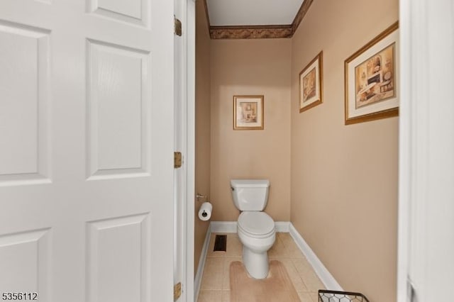 bathroom featuring toilet, baseboards, and tile patterned floors