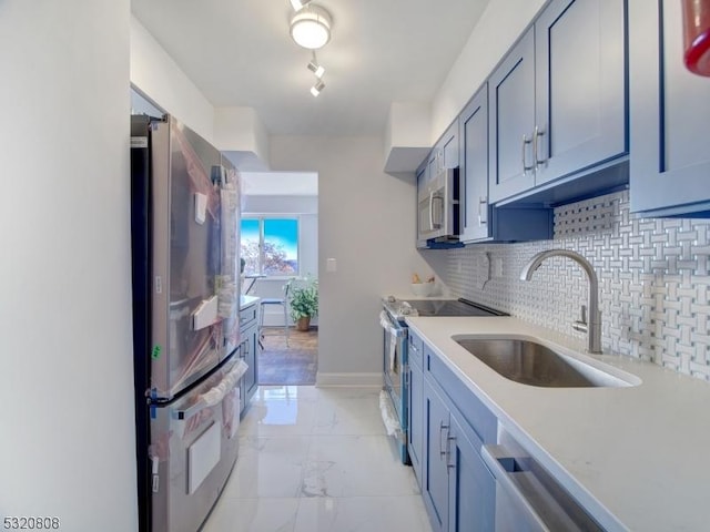 kitchen featuring a sink, appliances with stainless steel finishes, light countertops, decorative backsplash, and light marble finish floors