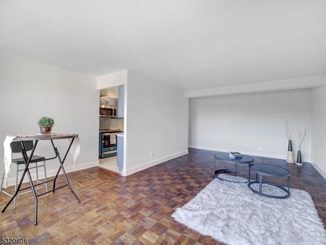 living area featuring baseboards