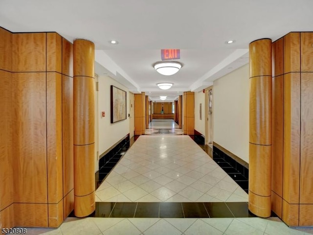hallway with tile patterned floors, baseboards, and recessed lighting
