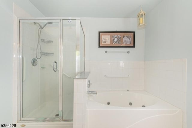 bathroom with a stall shower and a whirlpool tub