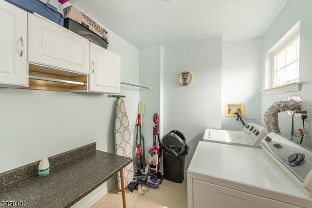 laundry area featuring cabinet space, independent washer and dryer, and light floors