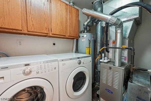 laundry room with cabinet space, water heater, and washer and clothes dryer