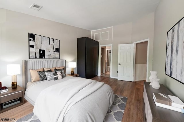 bedroom with visible vents and wood finished floors