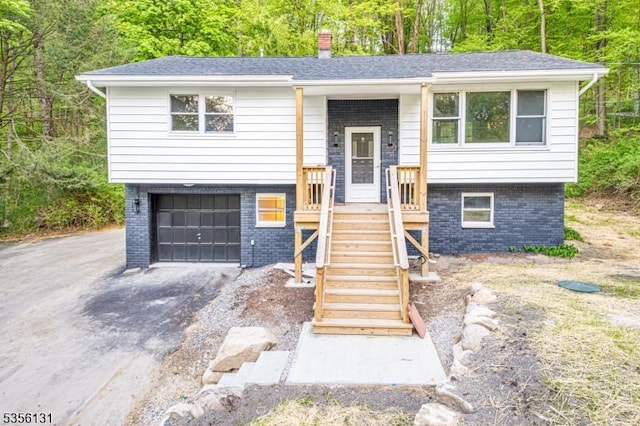 10 Maple Dr, Vernon Twp, NJ 07461 - split foyer home with brick siding, a chimney, driveway, and an attached garage