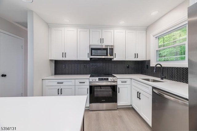 10 Maple Dr, Vernon Twp, NJ 07461 - kitchen with appliances with stainless steel finishes, a sink, light countertops, white cabinets, and recessed lighting