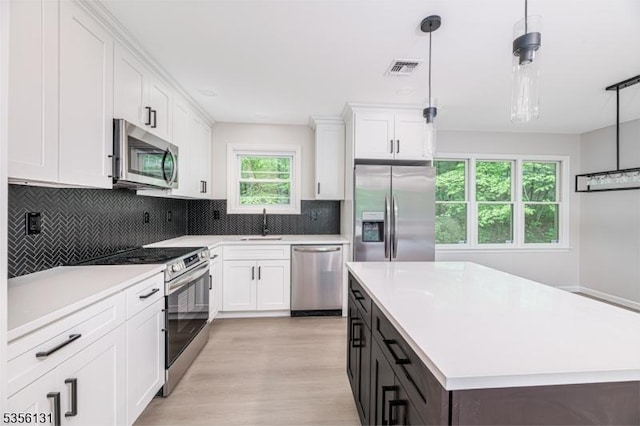 10 Maple Dr, Vernon Twp, NJ 07461 - kitchen with appliances with stainless steel finishes, a sink, light countertops, and white cabinets