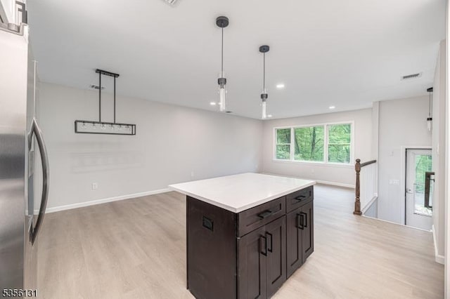 10 Maple Dr, Vernon Twp, NJ 07461 - kitchen featuring freestanding refrigerator, light wood finished floors, light countertops, a kitchen island, and dark brown cabinets