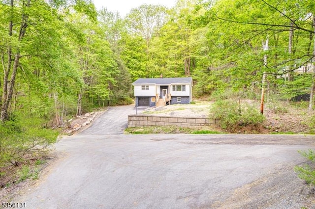 10 Maple Dr, Vernon Twp, NJ 07461 - bi-level home with asphalt driveway and a wooded view