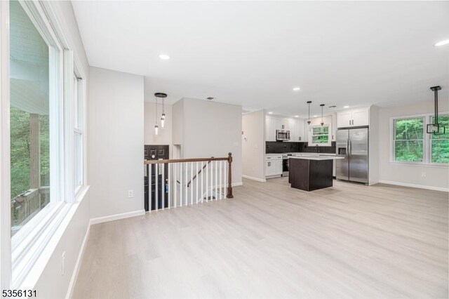10 Maple Dr, Vernon Twp, NJ 07461 - kitchen with stainless steel appliances, baseboards, a kitchen island, light wood finished floors, and recessed lighting