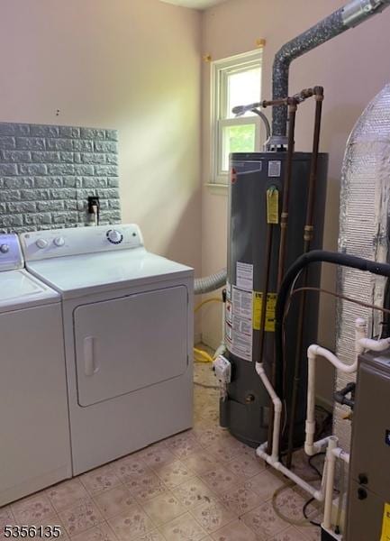 washroom featuring washer and clothes dryer and water heater