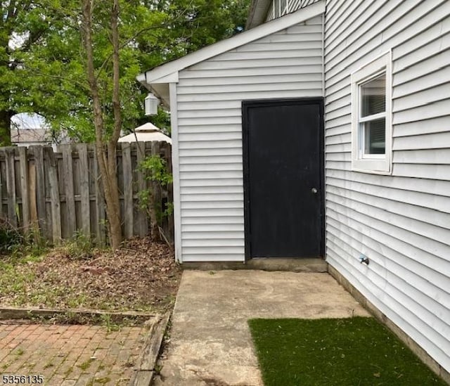 view of outbuilding featuring fence