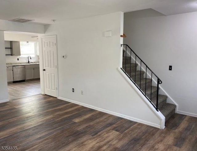 staircase with wood finished floors and baseboards