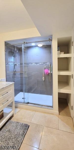 bathroom featuring a stall shower, tile patterned floors, and vanity