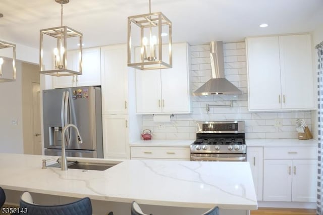 kitchen with white cabinets, wall chimney exhaust hood, stainless steel appliances, and decorative backsplash
