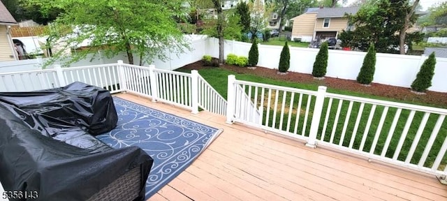wooden deck featuring fence and a lawn