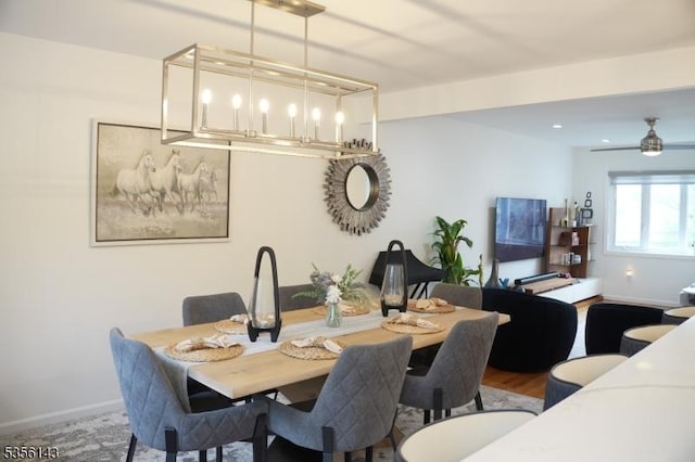 dining room with wood finished floors, baseboards, and a ceiling fan