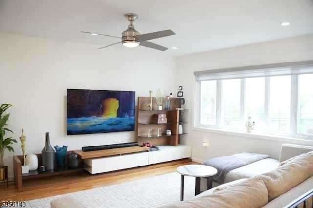 living area with a ceiling fan, baseboards, recessed lighting, and wood finished floors