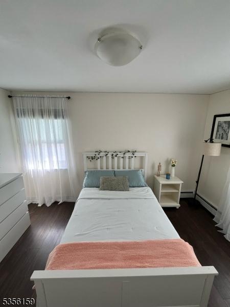 66 Lexington Ave, Rochelle Park Twp, NJ 07662 - bedroom featuring wood finished floors and a baseboard radiator