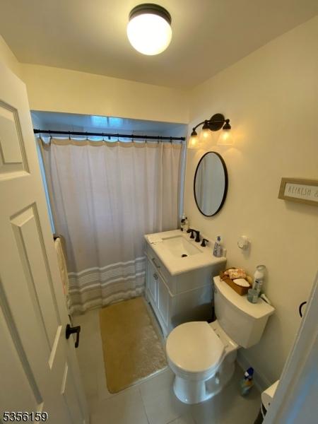66 Lexington Ave, Rochelle Park Twp, NJ 07662 - bathroom featuring tile patterned floors, toilet, vanity, and a shower with curtain