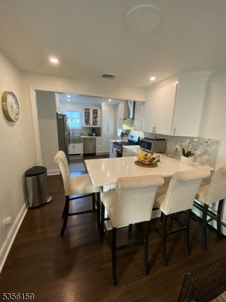 66 Lexington Ave, Rochelle Park Twp, NJ 07662 - dining area featuring baseboards, dark wood-style floors, and recessed lighting