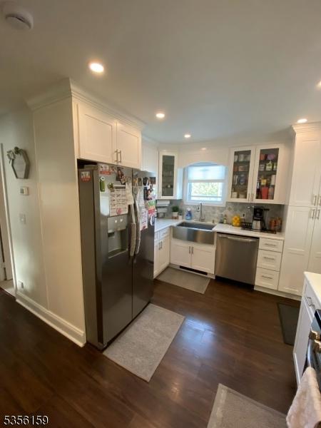 66 Lexington Ave, Rochelle Park Twp, NJ 07662 - kitchen with fridge with ice dispenser, dishwasher, a sink, white cabinets, and light countertops