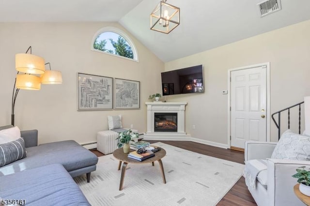 living area featuring dark wood finished floors, a glass covered fireplace, high vaulted ceiling, a chandelier, and a baseboard heating unit