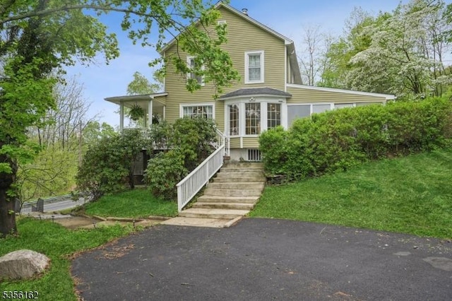 rear view of property with a yard