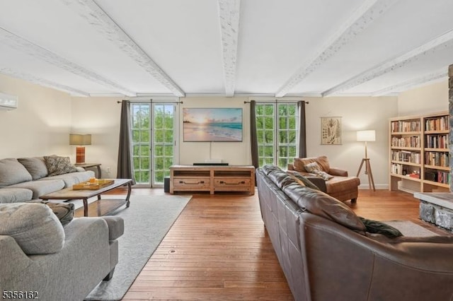 living area with beamed ceiling and hardwood / wood-style flooring