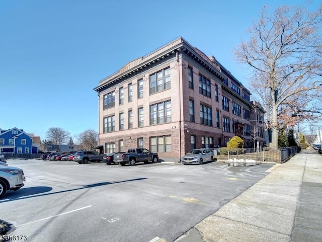 view of building exterior with uncovered parking
