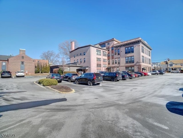 view of building exterior featuring uncovered parking